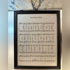 an old sheet music is framed in a black frame with the words, the first noel