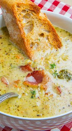 a close up of a bowl of soup with bread