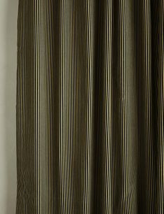 a black and white striped curtain hanging on a wall