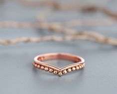 "Unique dainty dots Ring in a chevron shape, Made of 14k recycled solid gold, Perfect as a single ring or as a stacking ring, or as alternative stackable wedding rings. ✮ All gold used in my jewelry is recycled material. ✮ I believe It is our responsibility and privilege to take care of this planet, be conscious of our actions and footprints, do good, and spread love. ♥ ❀ \"love the earth as you would love yourself\" (John Denver) ❀ A perfect dainty wedding ring for the boho bridal! Each ring is