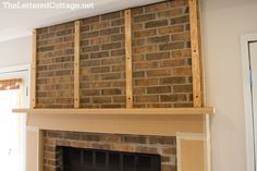 a brick fireplace in a living room under construction