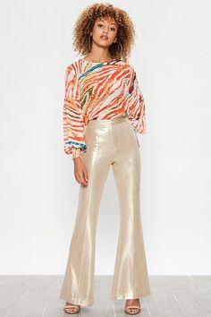 A Faux Leather Pant featuring bell bottom with front zip closure. Seamed Metallic Gold S (4-6) M (6-8) L (8-10) 91% Polyester 9% Spandex Faux Leather Pant, Metallic Pants, Metal Clothing, Leather Pant, Unique Boutique, Fashion Week Runway, Buy Gold, Faux Leather Pants, Bell Bottom