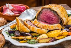 roast beef and potatoes on a white plate