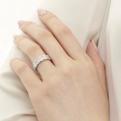 a woman's hand with a diamond ring on it