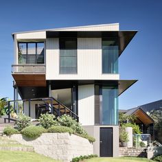 a modern house with two levels and balconies