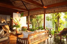 a living room with wooden furniture and plants