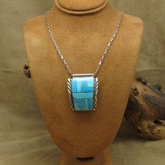 "Sterling silver inlay pendant with turquoise stones.  The turquoise is various shades of blue.  The pendant is curved and has a stamped design on the borders.  The pendant may have been a watchband at one time.  The pendant measures 1 5/16\" tall and is 1 1/16\" at the widest point.  It is stamped \"AY\" and \"Sterling\".  The sterling silver link chain measures 18\".  It is not removable.  Thank you for shopping in my store. Please let me know if you have questions. MS-4 + *The color you see o Mabe Pearl Necklace, Lapis Pendant, Silver Link Chain, Mabe Pearl, Daisy Necklace, Square Pendant, Turquoise Stones, Leaf Necklace, Pearl Stud Earrings