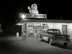 an old car parked in front of a store