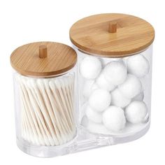 two clear jars filled with white cotton swabs and wooden lids, one is empty