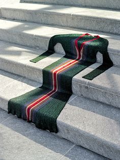 a green and red striped rug sitting on top of some concrete steps with the words beyondthemag above it