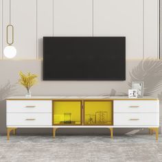 a white and yellow entertainment center with a flat screen tv on the wall above it