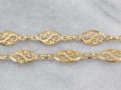 This chain necklace is made up of gorgeous marquise shaped links, crafted of fine 18 karat gold filigree! Delicate milgrain adds a touch of sparkle to this shining piece, while the overall styling is sophisticated and elegant. The length of this necklace makes it ideal for layering. Metal: 18K Yellow Gold Width of Chain: 7.5 mm Length of Chain: 28 Inches Marks: "750 18 AR" Stamped on the clasp Anchor Chain, Layered Chains, Link Chain Necklace, Gold Filigree, Chain Link Necklace, Link Necklace, Snake Chain, Chain Styles, Link Chain