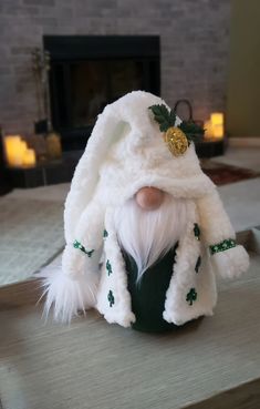 a white stuffed animal wearing a green hat