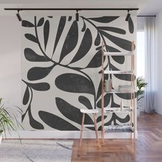 a living room with a large wall mural in black and white