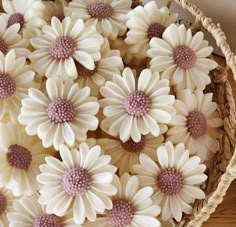 some white and pink flowers in a basket