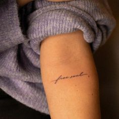 a woman's arm with a tattoo that reads, love is in the air