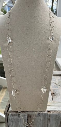 "this stunning best seller is back one-of-a-kind.  simpli-timeless \"gabi\" necklace ~ polished clear crystal quartz stones affixed to hammered sterling silver chain. approximately 34\". sterling toggle clasp with bleu swarovski. wear solo - doubled at the neck, long, layered and pair with other simplibleu. perfection!  the \"gabi\" is your go-to necklace for the boardroom, office, classroom, cocktails, parties and wherever you want to make a classic statement!  each piece is handmade, please allow for some variability from the photographs and hammered chain as shown above.  please convo me or leave a note at checkout with questions or customizing. free local pickup/delivery is available for free, please see Q&A.   all pieces arrive in simplibleu gift bags! ** please check shipping time fo Elegant Clear Single Strand Crystal Necklace, Elegant Single Strand Clear Crystal Necklace, Elegant Clear Faceted Crystal Necklaces, Elegant Silver Glass Crystal Necklace, Elegant Glass Wire Wrapped Necklaces, Elegant Clear Quartz Crystal Necklace, Elegant Silver Crystal Necklace With Wire Wrapping, Elegant Clear Crystal Necklaces In Sterling Silver, Elegant Silver Wire Wrapped Crystal Necklace