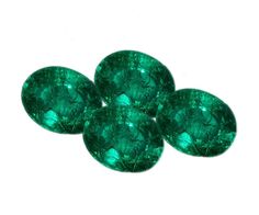 three emerald green stones sitting next to each other