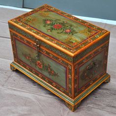 an ornately painted wooden box sitting on the ground