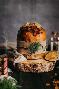 a cake sitting on top of a piece of wood next to candles and other decorations