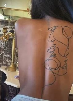 a woman with a tattoo on her back