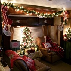 a living room filled with furniture and christmas decorations