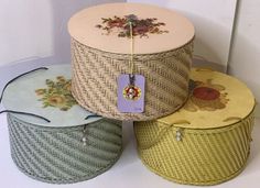 three baskets are stacked on top of each other with tags hanging from the handles and sides