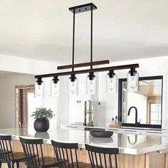 a kitchen island with four chairs around it