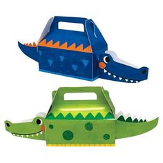 two cardboard crocodiles are next to each other, one is green and the other is blue