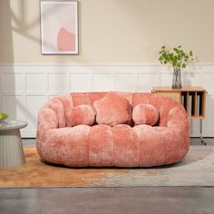 a living room filled with furniture and a rug on the floor next to a table