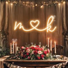 a table topped with flowers and candles next to a sign that says we love you