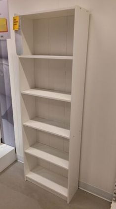 an empty white book shelf in a room