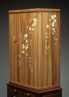 a wooden cabinet with flowers painted on it