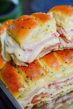 two sandwiches stacked on top of each other with cheese and meat in the middle,