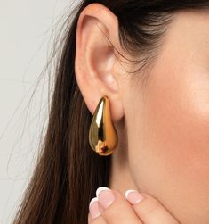 These are lightweight and waterproof! We love these statement droplet earrings for their the organic and playful shape. Style these oversized droplet earrings up for a fun night out or make them an essential part of your daily line up.
Material: 18K Gold Plated On Stainless Steel, Size: 1.25" x .65" Modern Teardrop Drop Earrings Tarnish Resistant, Modern Gold Teardrop Drop Earrings, Modern Hypoallergenic Drop Teardrop Earrings, Trendy 14k Gold-filled Drop Earrings, Rain Drop Earrings Gold, Droplet Earrings, Skin Allergies, Zodiac Necklaces, Flower Bracelet