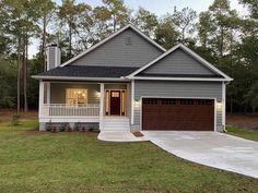 a gray house with a brown garage door