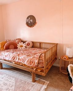 a baby's room with pink walls and furniture