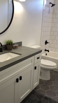 a bathroom with a sink, toilet and bathtub in the background is a tiled floor