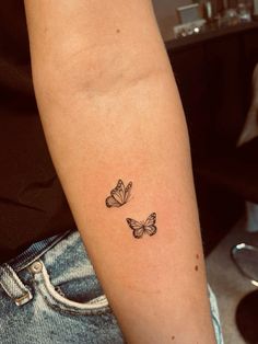 two butterflies tattoo on the arm