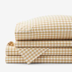 the sheets and pillowcases are folded up on top of each other in checkered patterns