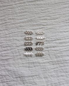 several different metal numbers on a white towel