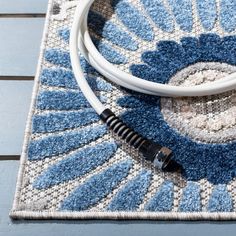 a white and black cable connected to a blue rug