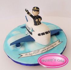 a birthday cake for a pilot on top of an airplane with the name wendy's cake