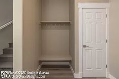 an empty walk in closet with stairs leading up to the second floor and another door is open