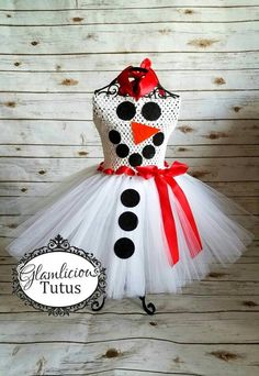 a dress made to look like a snowman with polka dots and a red bow