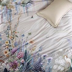 an image of a bed with flowers and birds on it