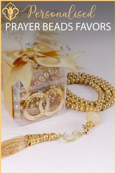 a box with pearls and gold jewelry in it that says, personalised prayer beads favors