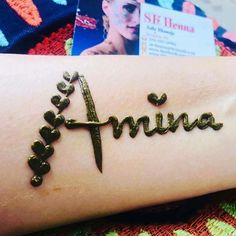 a woman's arm with the word aruna written in cursive writing