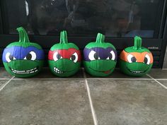 three pumpkins painted to look like teenage mutant turtles