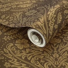 an image of a wallpaper with gold and brown designs on it's surface